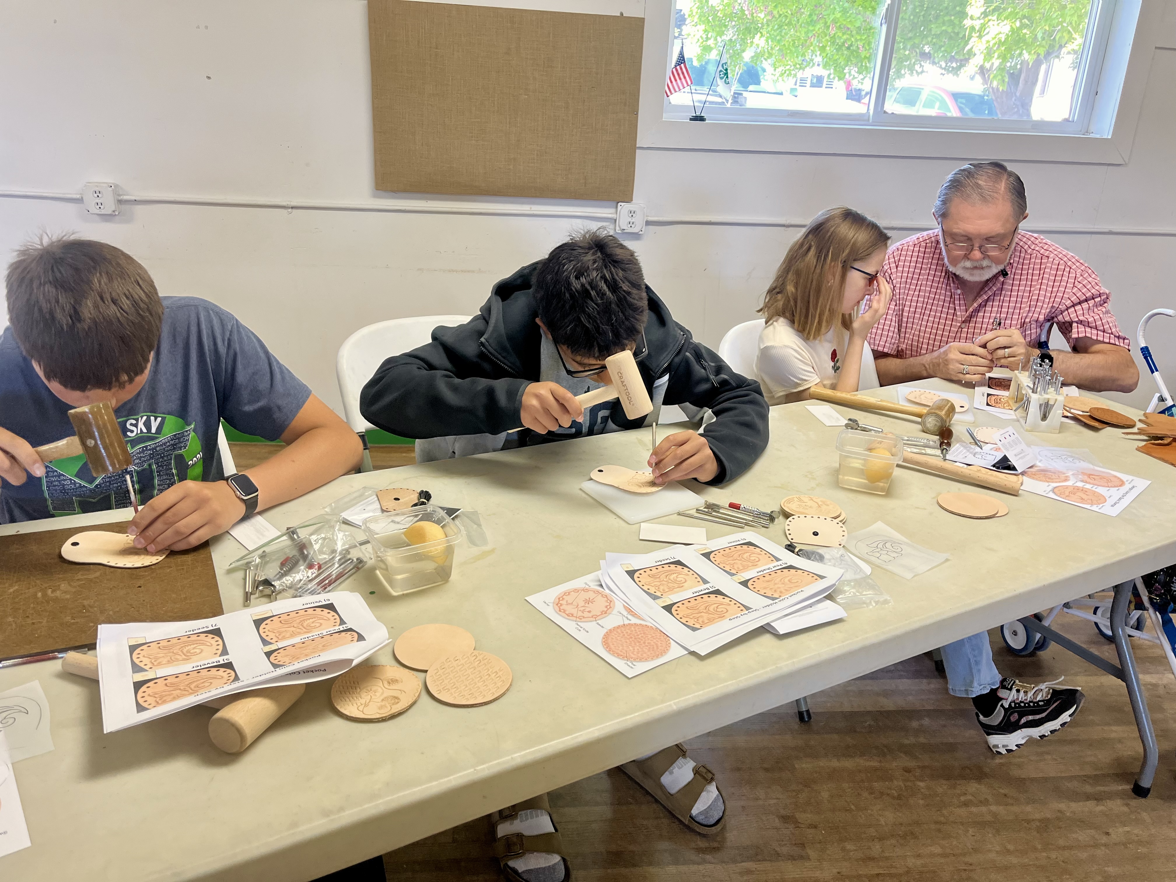 Students hard at work, and Jim Linnell helping out a younger 4-H’er 